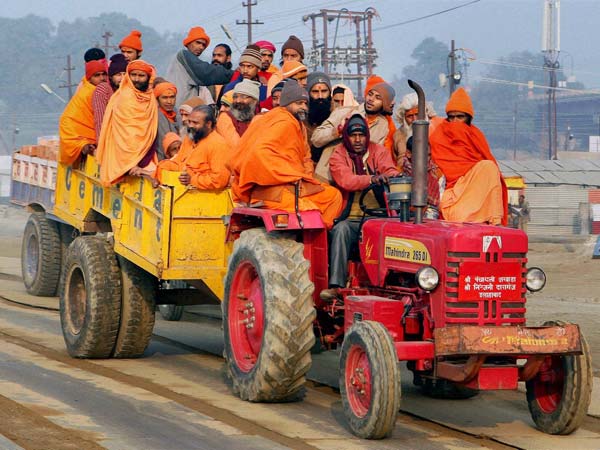 Sadhus arrive by a tractor at Sangam