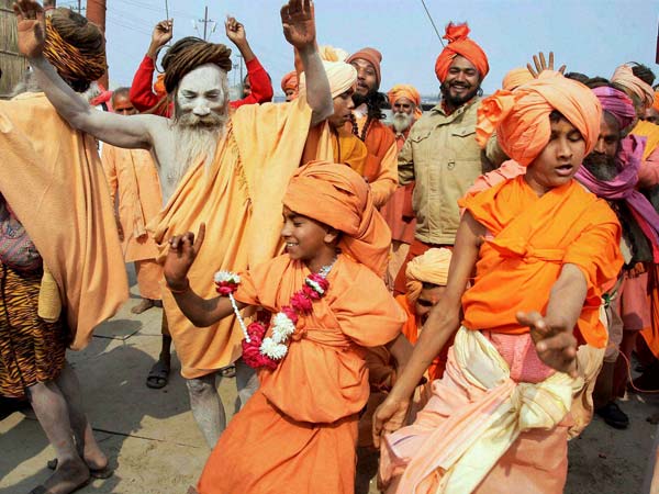 Sadhus dance during a flag raising ceremony