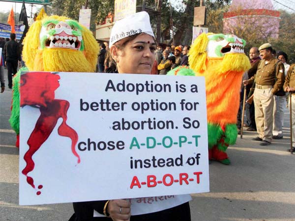 A woman displays a placard