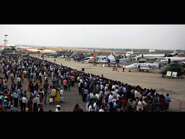 Visitors having a look of parked aircrafts