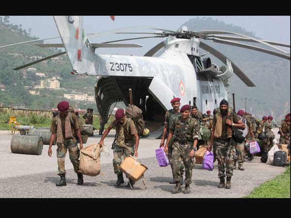 Army men carrying relief material
