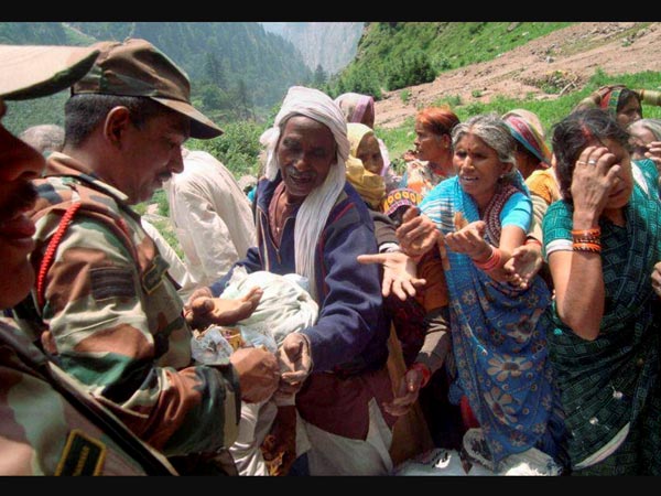 Army personnel provide food to stranded pilgrims