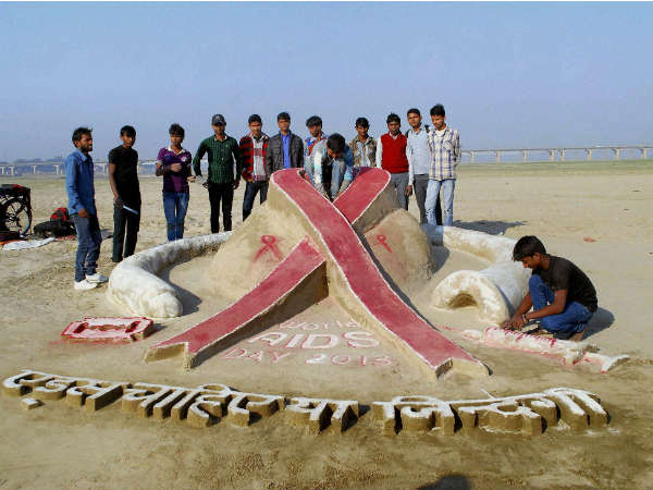 An artist making a sand sculpture on AIDS awareness