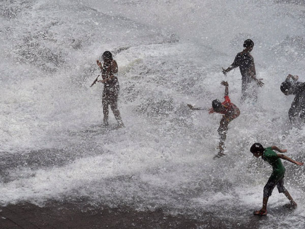 People enjoy high tide at Marine drive in Mumbai