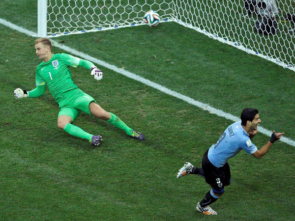 Uruguay's Luis Suarez, right, celebrates scoring the opening goal