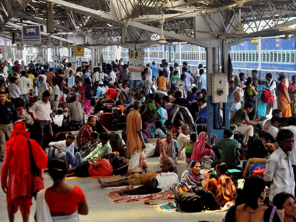 Railway passengers wait at Guwahati Railway Station