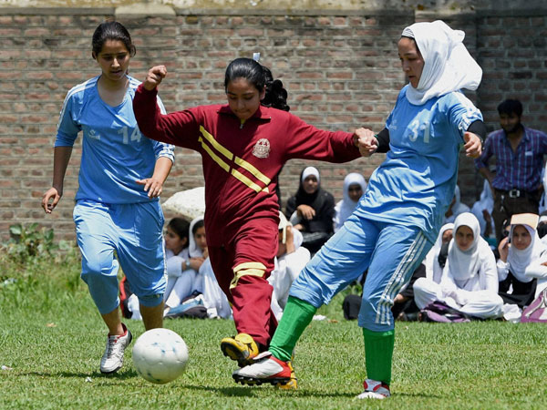 School girls in action during a football tournament