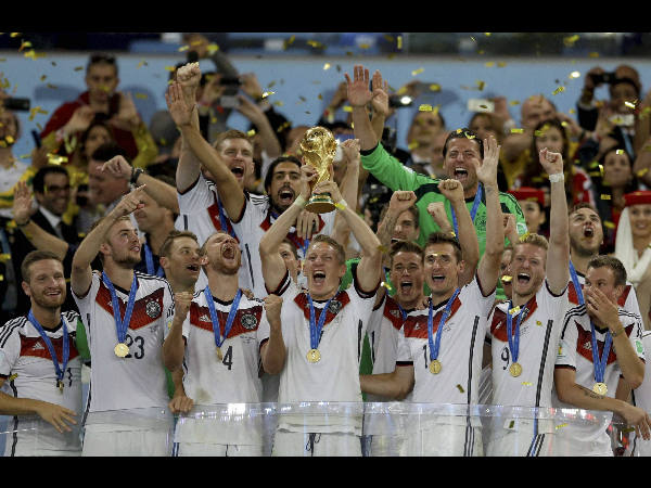 Bastian Schweinsteiger (with the trophy) celebrates with team-mates after winning FIFA World Cup 2014 Bastian Schweinsteiger (with the trophy) celebrates with team-mates after winning FIFA World Cup 2014