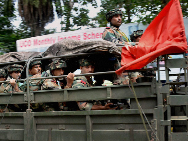 Army personnel carrying out a flag march