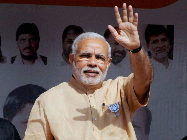 Prime Minister Narendra Modi waves at an election campaign rally