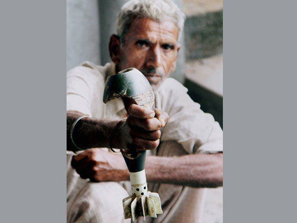 A villager displays a mortar shell fired