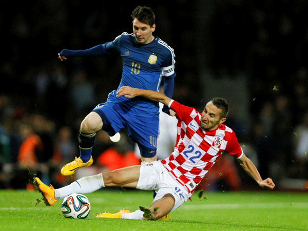 Argentina's Lionel Messi, left, vies for the ball