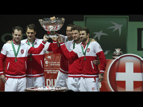 Team Switzerland with coach Severin Luthi, left, Roger Federer, second left, and Stanislas Wawrinka, second right, hold the trophy after winning the Davis Cup final Team Switzerland with coach Severin Luthi, left, Roger Federer, second left, and Stanislas Wawrinka, second right, hold the trophy after winning the Davis Cup final