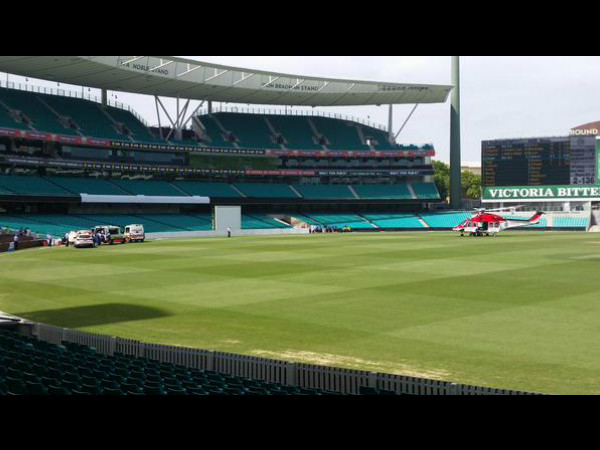 Left: Hughes treated by medical staff as air ambulance lands (right). Photo: Mark Travers (Via Twitter) Left: Hughes treated by medical staff as air ambulance lands (right). Photo: Mark Travers (Via Twitter)