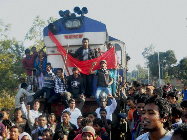 Activist of All Assam tea tribe student association stop a train at Salina Railway Station in Nagaon Dist during the 12 hr Assam Bandh called by different Adivasi Organization against the Bodo militant attacks, on Friday. Activist of All Assam tea tribe student association stop a train at Salina Railway Station in Nagaon Dist during the 12 hr Assam Bandh called by different Adivasi Organization against the Bodo militant attacks, on Friday.