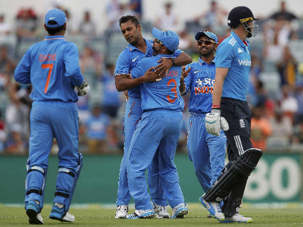 Stuart Binny, second left, is congratulated by teammates after taking the wicket of England's Joe Root, right Stuart Binny, second left, is congratulated by teammates after taking the wicket of England's Joe Root, right