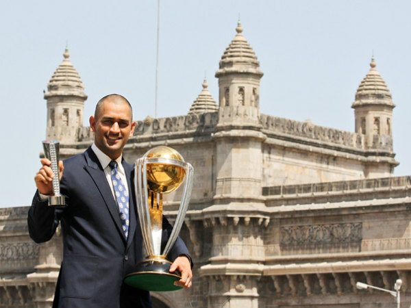 Dhoni with the big trophy and Man-of-the-final award in 2011 Dhoni with the big trophy and Man-of-the-final award in 2011