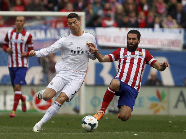 Atletico and Real Madrid players in action Atletico and Real Madrid players in action