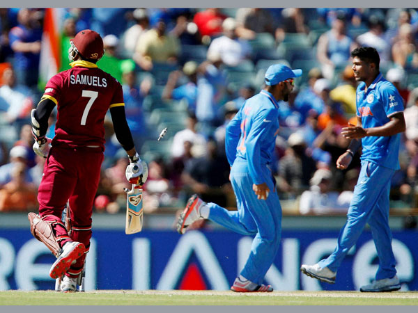 Samuels (left) is run out by Kohli (centre). Also seen is Umesh Yadav Samuels (left) is run out by Kohli (centre). Also seen is Umesh Yadav