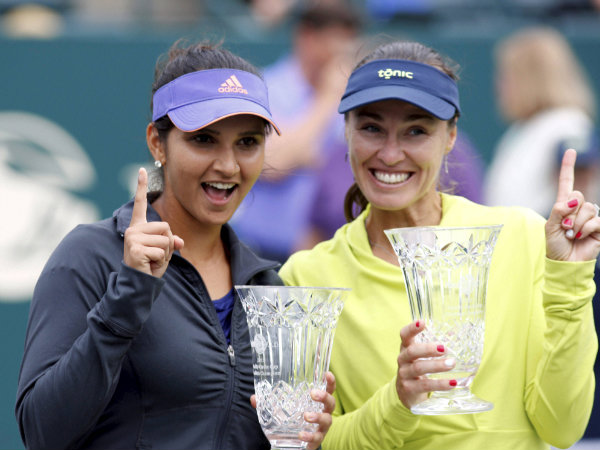 Sania Mirza (left) and her teammate Martina Hingis with their WTA Family Circle title Sania Mirza (left) and her teammate Martina Hingis with their WTA Family Circle title