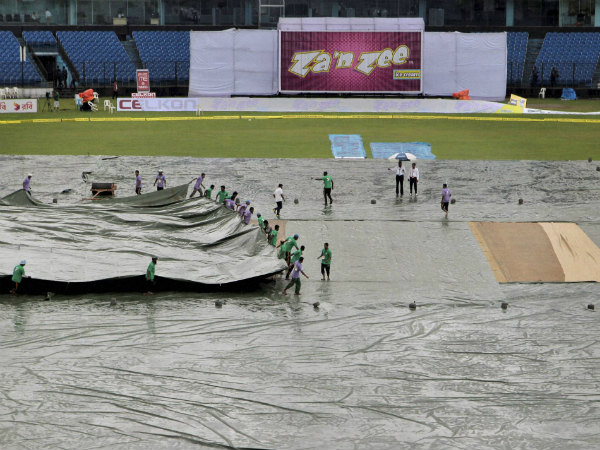 Bangladesh’s ground staff pull covers on the field following a spell of rain during the second day Bangladesh’s ground staff pull covers on the field following a spell of rain during the second day