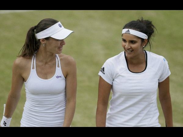 Martina Hingis, left, and Sania Mirza, talk between points during their doubles match against Casey Dellacqua and Yaroslava Shvedova Martina Hingis, left, and Sania Mirza, talk between points during their doubles match against Casey Dellacqua and Yaroslava Shvedova