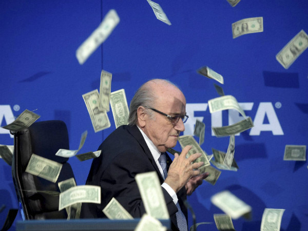 FIFA president Sepp Blatter is photographed while banknotes thrown by British comedian Simon Brodkin hurtle through the air during a press conference FIFA president Sepp Blatter is photographed while banknotes thrown by British comedian Simon Brodkin hurtle through the air during a press conference