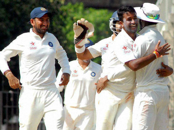 Ojha (second right) celebrates with team-mates after taking a wicket Ojha (second right) celebrates with team-mates after taking a wicket