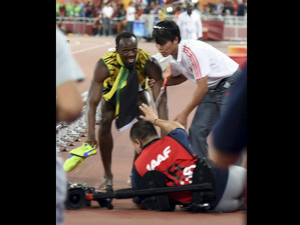 In this photo released by Xinhua News Agency, Bolt gets up after he is rammed by a cameraman on a segway as he celebrates after winning the gold in the men's 200m final In this photo released by Xinhua News Agency, Bolt gets up after he is rammed by a cameraman on a segway as he celebrates after winning the gold in the men's 200m final