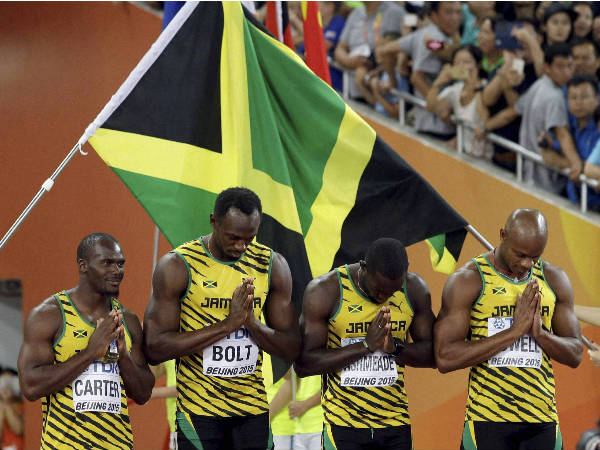 The Jamaican team bows as they enter the arena prior to winning the gold medal in the 4x100m relay The Jamaican team bows as they enter the arena prior to winning the gold medal in the 4x100m relay