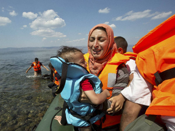 Syrian migrant mother holding her child breaks into tears
