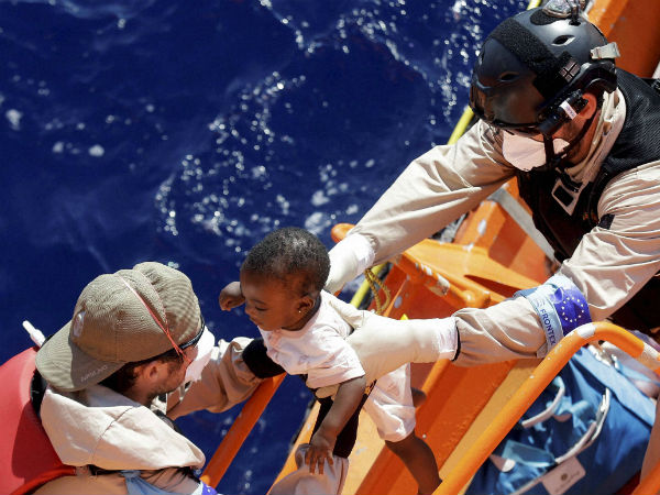 A baby is helped to board on the Norwegian Siem Pilot ship