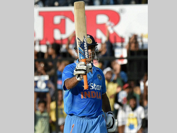 Dhoni raises his bat after completing half century Dhoni raises his bat after completing half century
