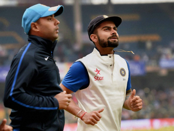 Kohli (right) and Stuart Binny run during a rain break in Bengaluru Kohli (right) and Stuart Binny run during a rain break in Bengaluru