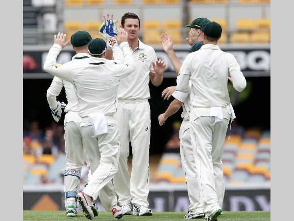 File photo: Australia's Josh Hazlewood (centre) and his team-mates celebrate a New Zealand wicket. The players are gearing up for first-ever day-night Test File photo: Australia's Josh Hazlewood (centre) and his team-mates celebrate a New Zealand wicket. The players are gearing up for first-ever day-night Test