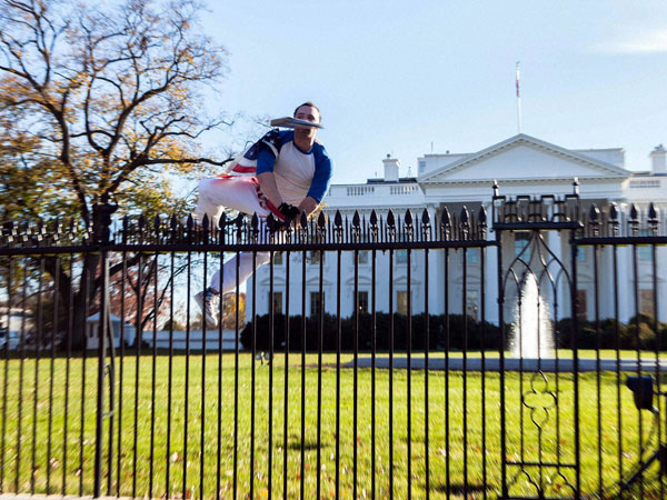 In this photo provided by Vanessa Pena, a man jumps a fence at the White House. In this photo provided by Vanessa Pena, a man jumps a fence at the White House.