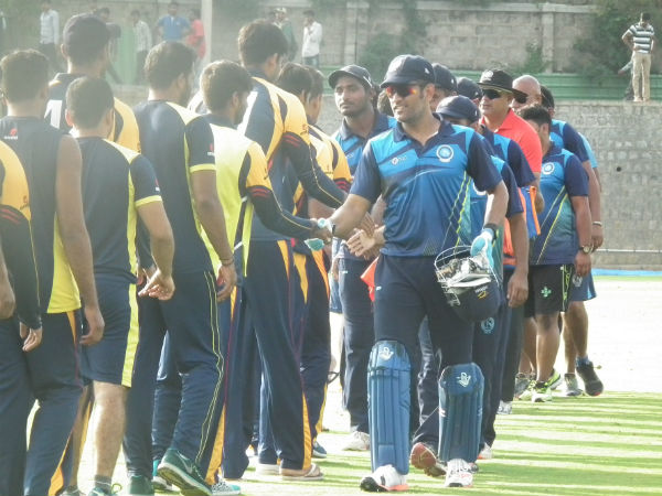 MS Dhoni (right) shakes hands with Karnataka players after the match. Photo by Aprameya .C MS Dhoni (right) shakes hands with Karnataka players after the match. Photo by Aprameya .C