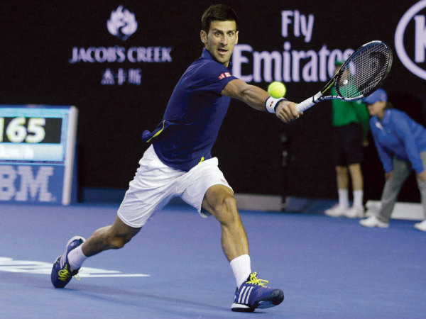 Novak Djokovic plays a backhand return to Roger Federer during their semi-final match Novak Djokovic plays a backhand return to Roger Federer during their semi-final match