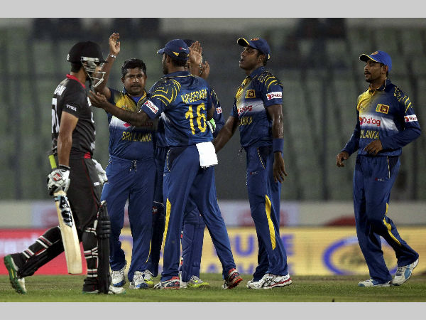 Sri Lanka's Rangana Herath, second left, celebrates the dismissal of United Arab Emirates’ Shaiman Anwar, left, with his teammates Sri Lanka's Rangana Herath, second left, celebrates the dismissal of United Arab Emirates’ Shaiman Anwar, left, with his teammates