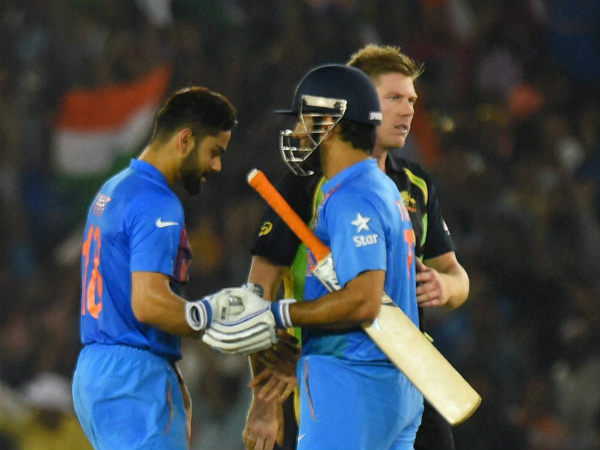 Kohli (left) and Dhoni celebrate India's win over Australia as James Faulkner watches on Kohli (left) and Dhoni celebrate India's win over Australia as James Faulkner watches on