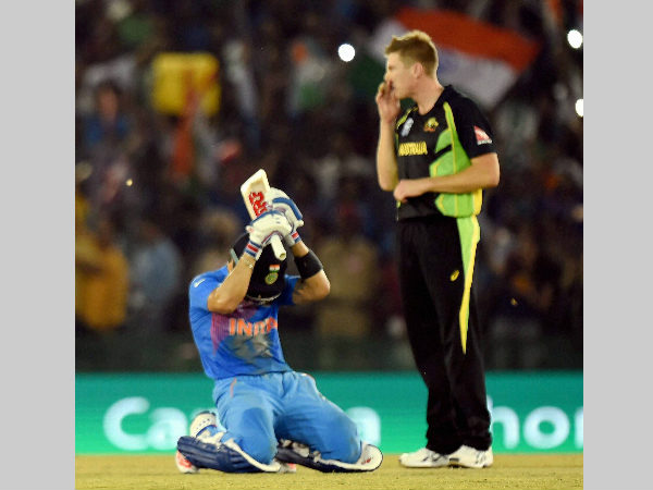 Kohli (left) is on the ground as he celebrates India's victory over Australia. Also seen is James Faulkner Kohli (left) is on the ground as he celebrates India's victory over Australia. Also seen is James Faulkner
