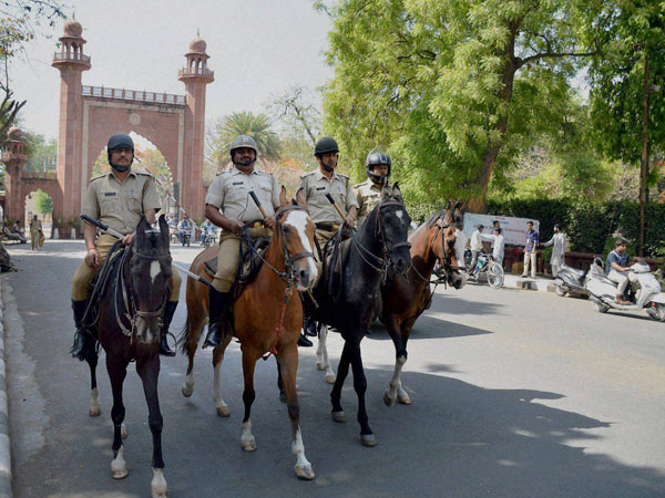 Police force deployed infront of Aligarh Muslim University gate after the clashes between two groups at University campus, in Aligarh on Sunday. Police force deployed infront of Aligarh Muslim University gate after the clashes between two groups at University campus, in Aligarh on Sunday.
