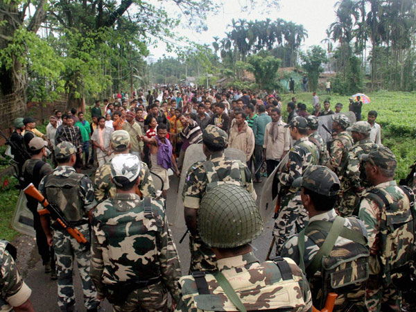 Army personnel trying to control the situation after a high voltage cable fell on a group of protesters in Pengiri in Assam's Tinsukia district following police firing on Monday. Army personnel trying to control the situation after a high voltage cable fell on a group of protesters in Pengiri in Assam's Tinsukia district following police firing on Monday.