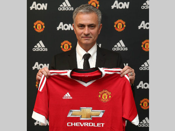Jose Mourinho holds Manchester United jersey on Friday. Photo from MU's Twitter page Jose Mourinho holds Manchester United jersey on Friday. Photo from MU's Twitter page