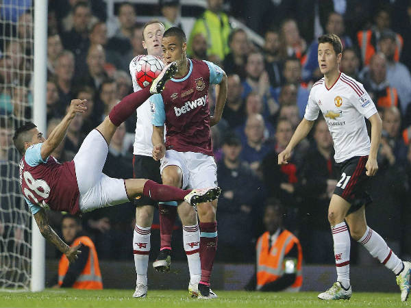 West Ham's Manuel Lanzini, left, shoots on goal during the English Premier League soccer match between West Ham and Manchester United at Boleyn Ground stadium in London on May 10. West Ham's Manuel Lanzini, left, shoots on goal during the English Premier League soccer match between West Ham and Manchester United at Boleyn Ground stadium in London on May 10.
