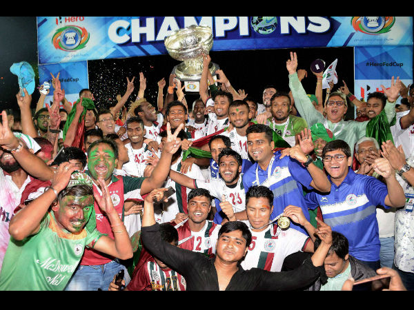 Players and officials of Mohan Bagan with winning trophy of Federation Cup 2016 after defeating Aizwal Football Club at Indira Gandhi Athletics Stadium, Sarusajai in Guwahati on Saturday. Mohan Bagan won by 5-0. Players and officials of Mohan Bagan with winning trophy of Federation Cup 2016 after defeating Aizwal Football Club at Indira Gandhi Athletics Stadium, Sarusajai in Guwahati on Saturday. Mohan Bagan won by 5-0.