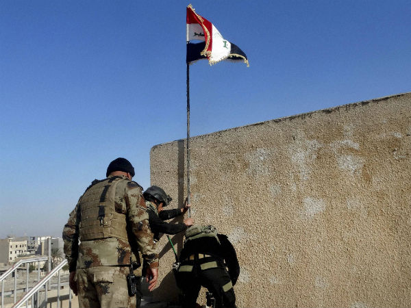 Iraqi soldiers plant a national flag in the government complex in central Ramadi, 70 miles (115 kilometers) west of Baghdad, Iraq. Iraqi soldiers plant a national flag in the government complex in central Ramadi, 70 miles (115 kilometers) west of Baghdad, Iraq.