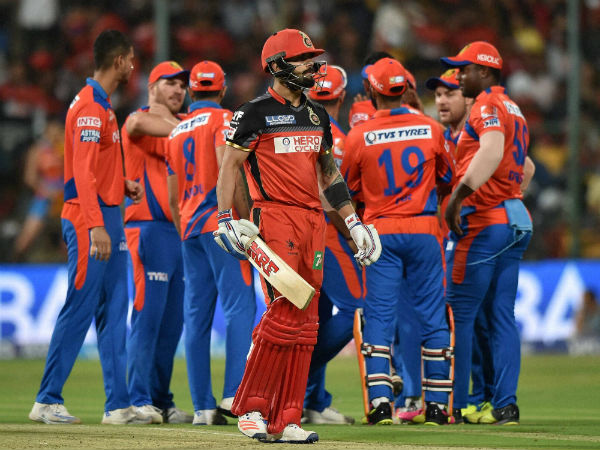Royal Challengers Bangalore's Virat Kohli returns the pavilion as Gujarat Lions players celebrate. Royal Challengers Bangalore's Virat Kohli returns the pavilion as Gujarat Lions players celebrate.