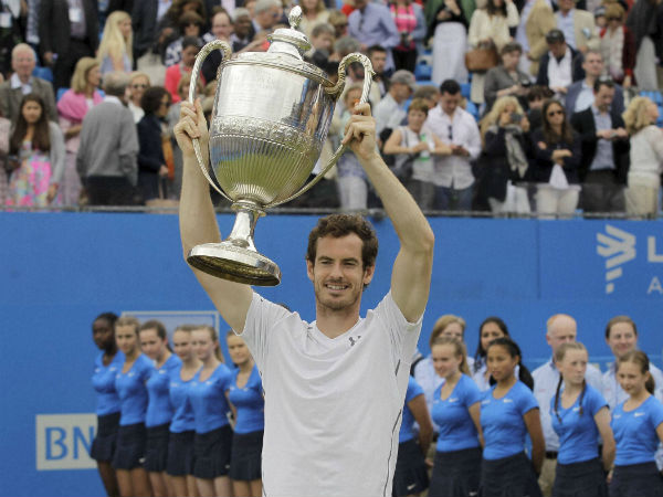 Andy Murray lifts the trophy after defeating Canada's Milos Raonic in their final match at Queen's Championships in London on Sunday (June 19) Andy Murray lifts the trophy after defeating Canada's Milos Raonic in their final match at Queen's Championships in London on Sunday (June 19)