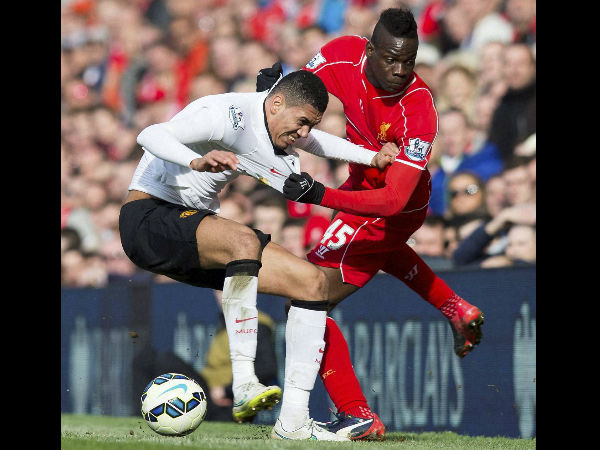 Liverpool's Mario Balotelli, right, fights for the ball against Manchester United's Chris Smalling during the English Premier League soccer match between Liverpool and Manchester United. Liverpool's Mario Balotelli, right, fights for the ball against Manchester United's Chris Smalling during the English Premier League soccer match between Liverpool and Manchester United.